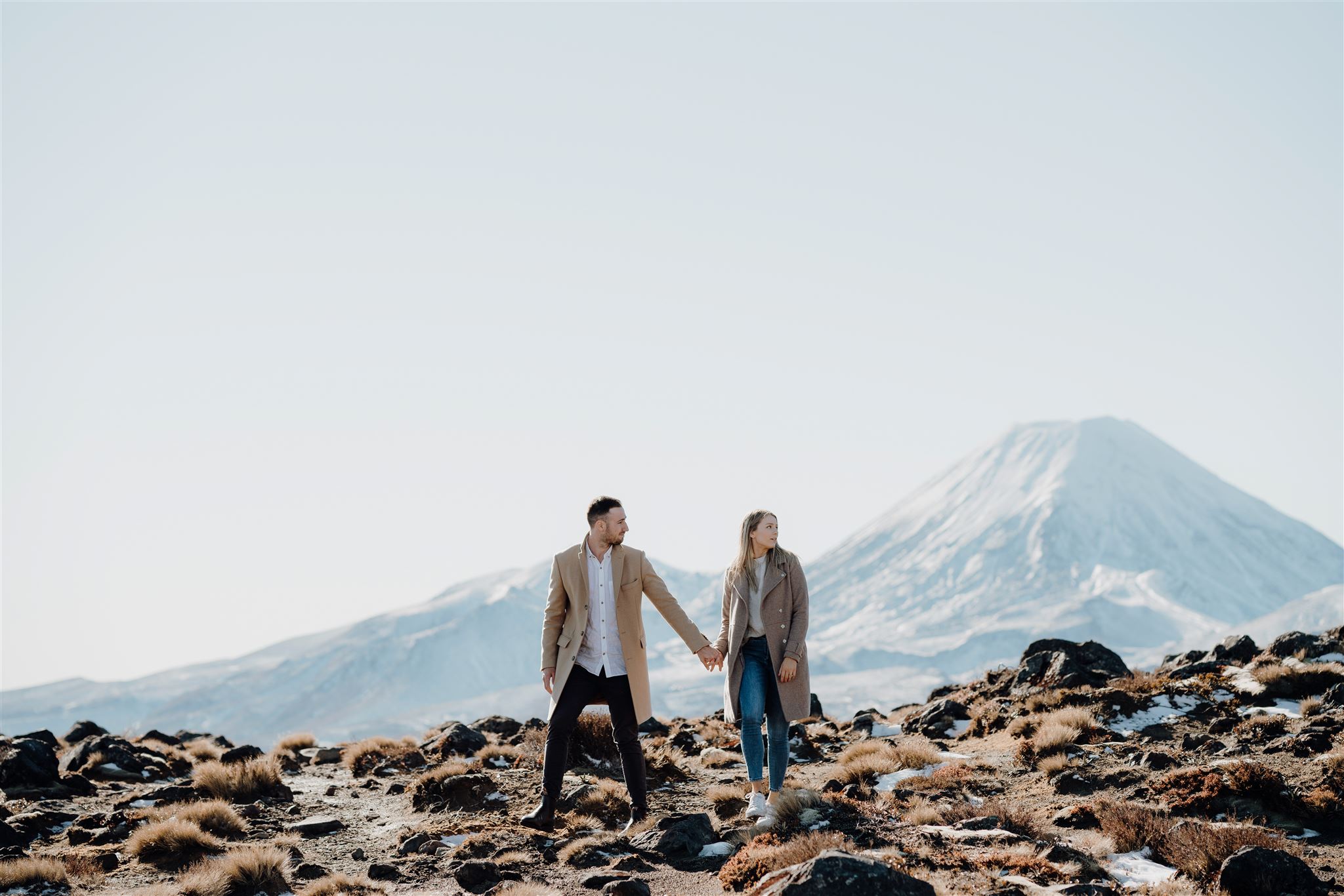 A couple photographed in front of Mt Ngauruhoe during an engagement photoshoot by waikato photographer haley adele photography