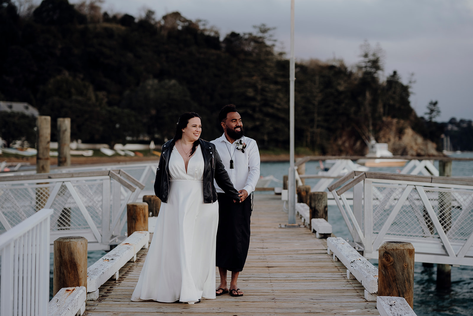 A bride and groom being photographed on Russells Wharf by Waikato Photographer Haley Adele Photography after being married at the Duke Of Marlborough