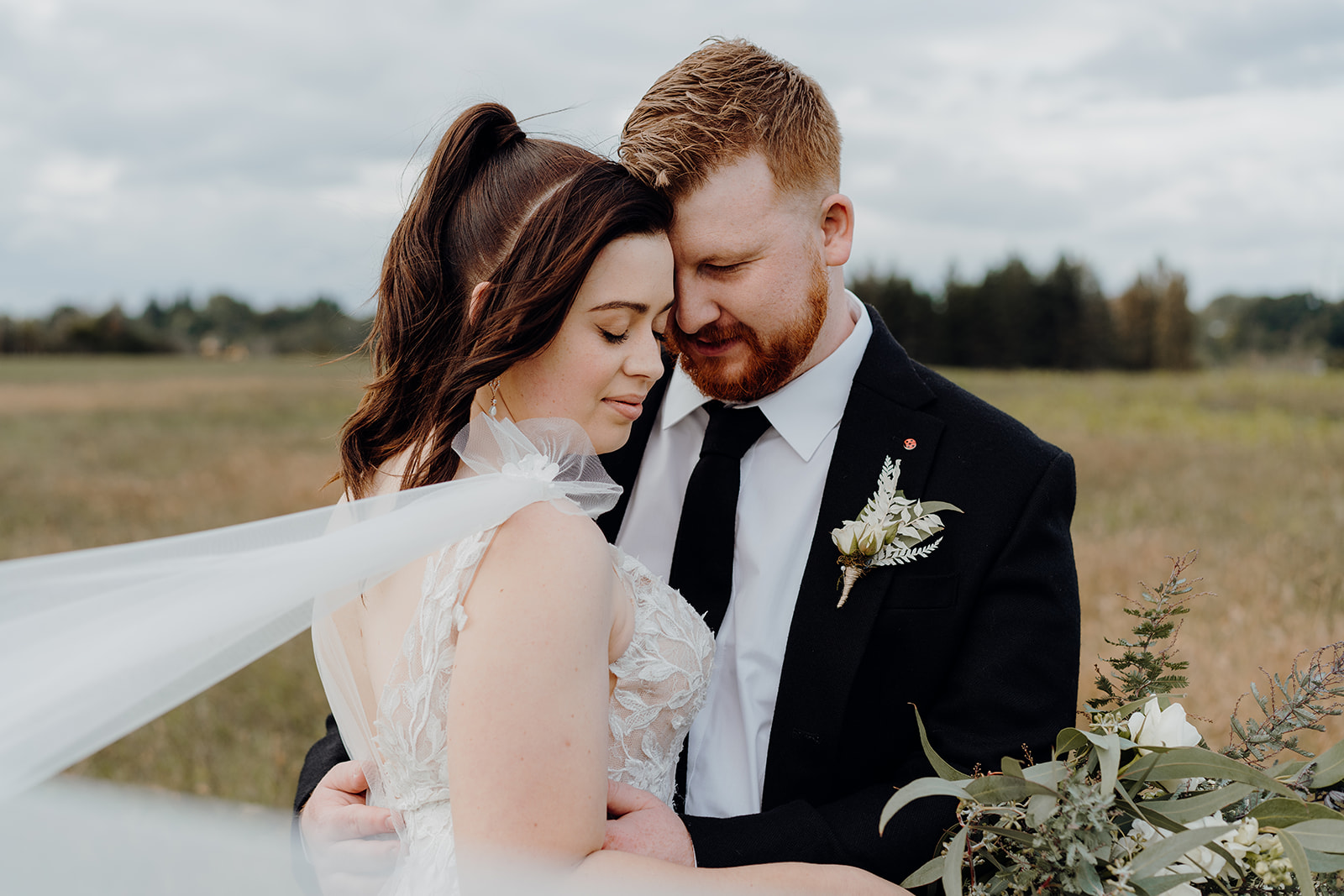 A bride and groom photographed on the corn fields outside of Narrows Landing, a waikato wedding venue, being posed and directed by Haley Adele Photography