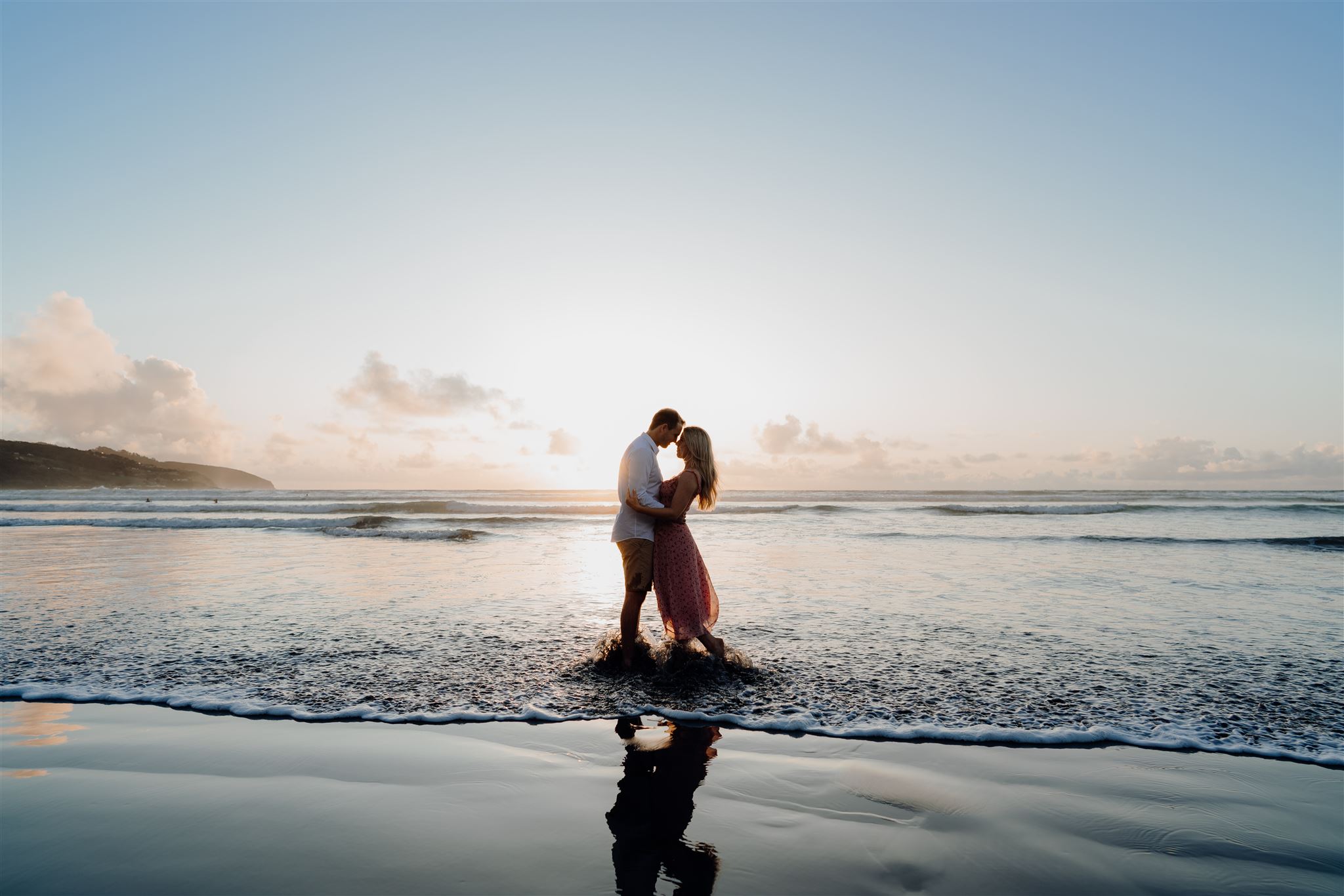A couple being photographed for pre-wedding photographs on the beach in Raglan by Waikato and Bay of Plenty Wedding Photographer Haley Adele Photography