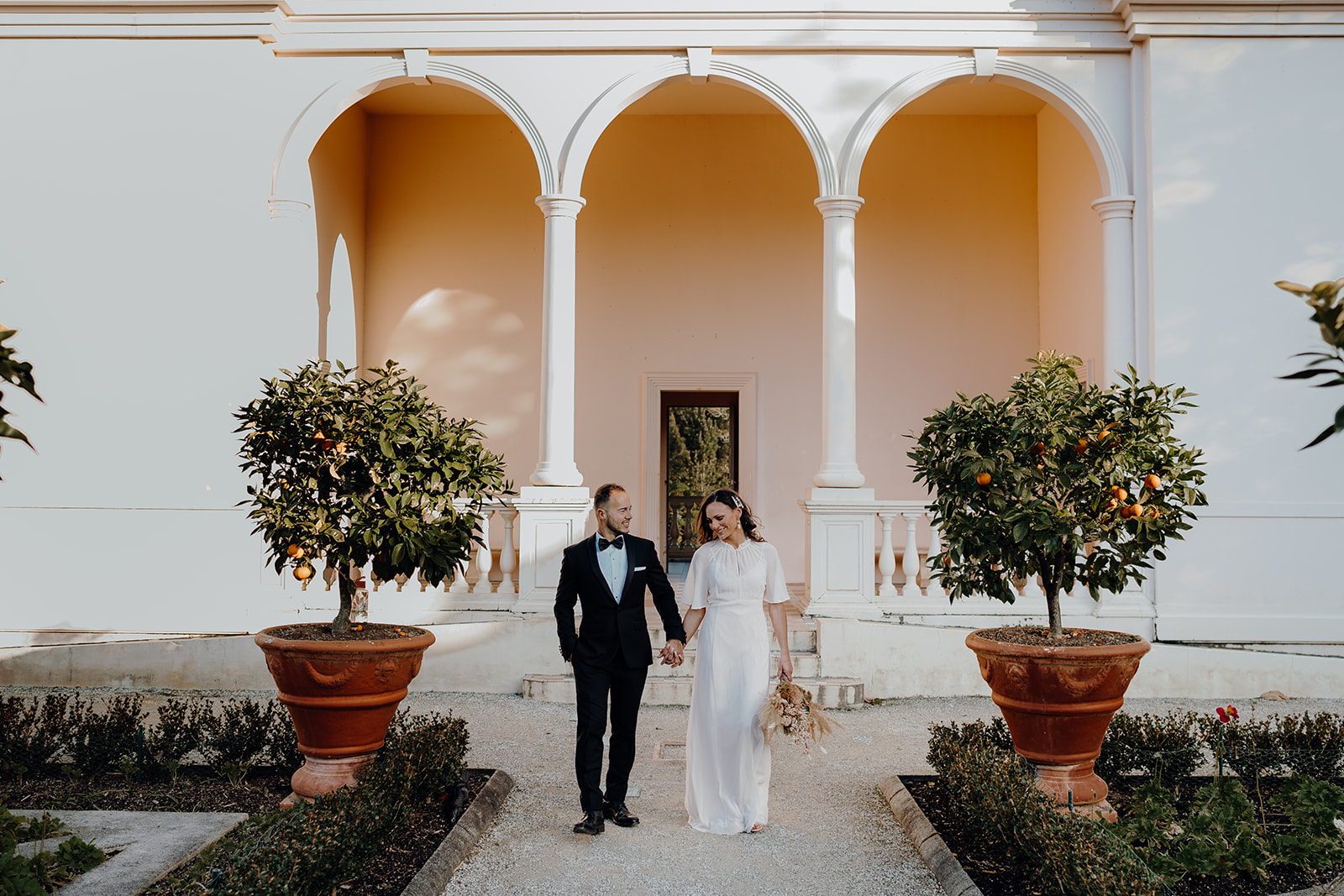 A couple standing in the Italian gardens in the Hamilton Gardens being photographed in their suit and wedding dress by Waikato wedding photographer Haley Adele Photography