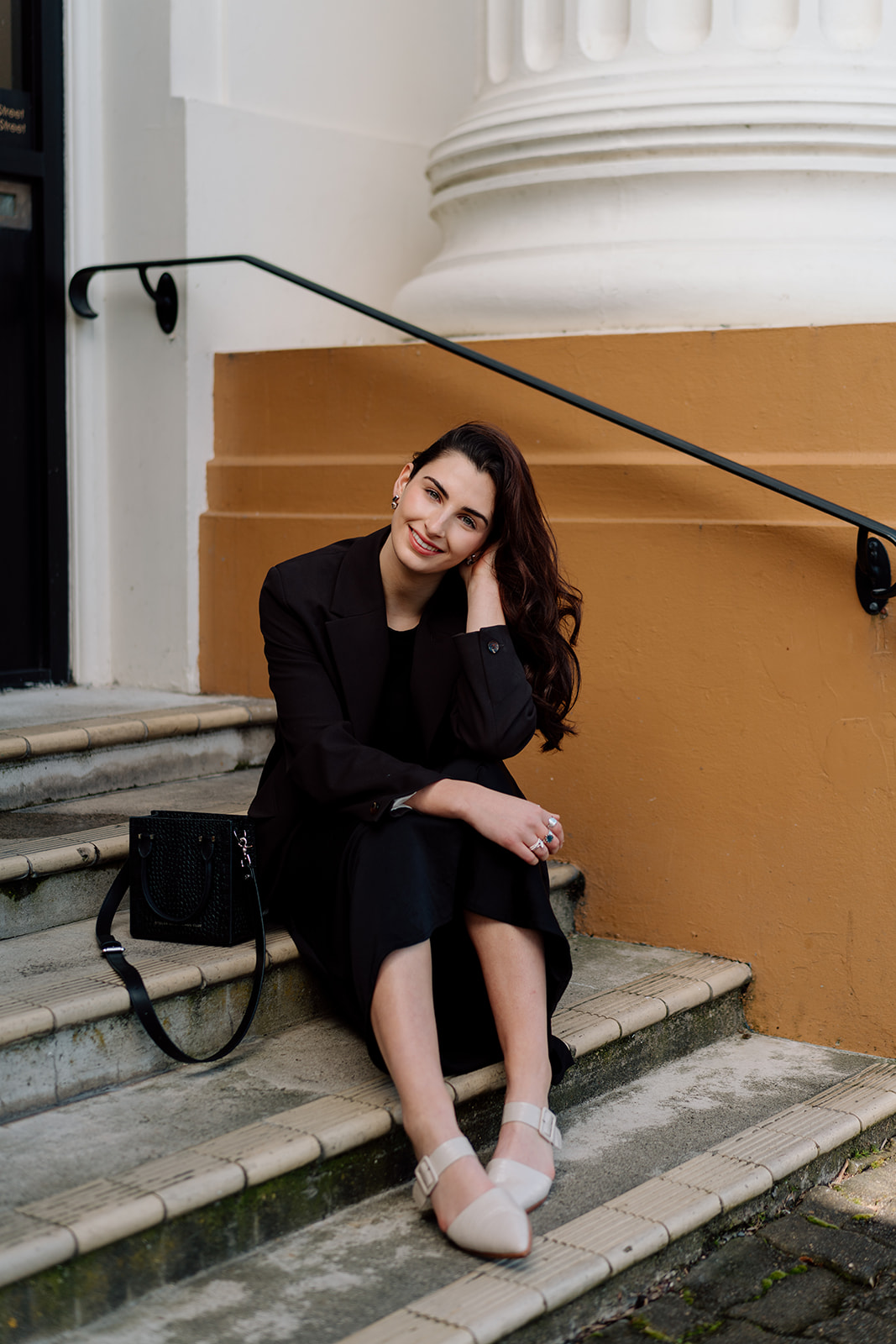 Freya sitting on a set of steps during her headshot branding photoshoot in hamilton central with haley adele photography