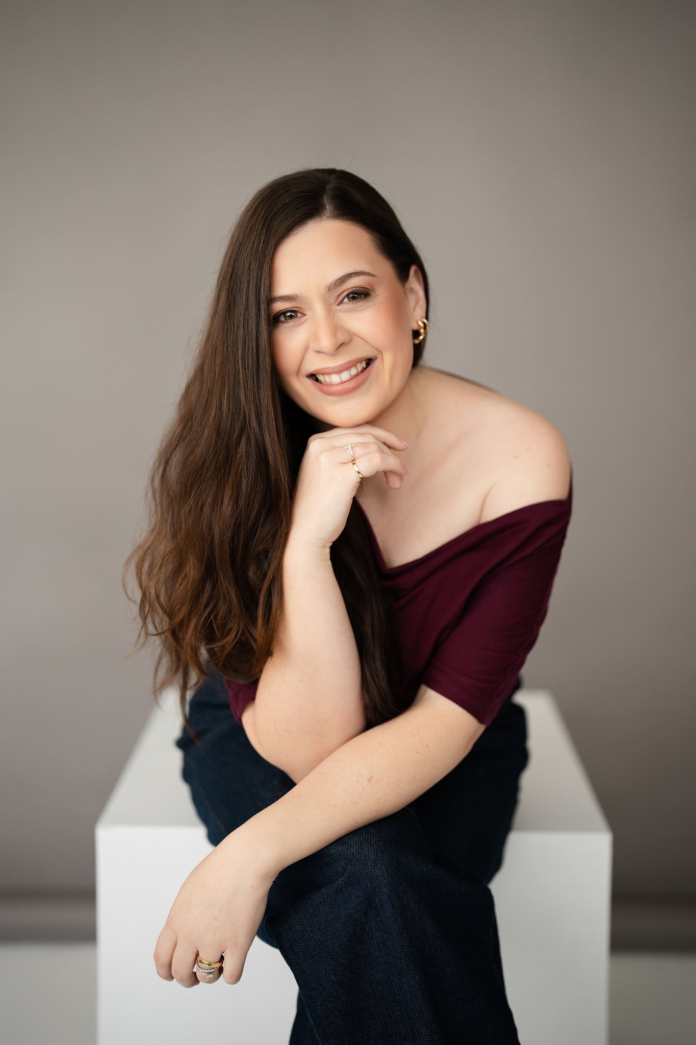 Kate photographed using a white posing box during a professional studio portrait session in Hamilton